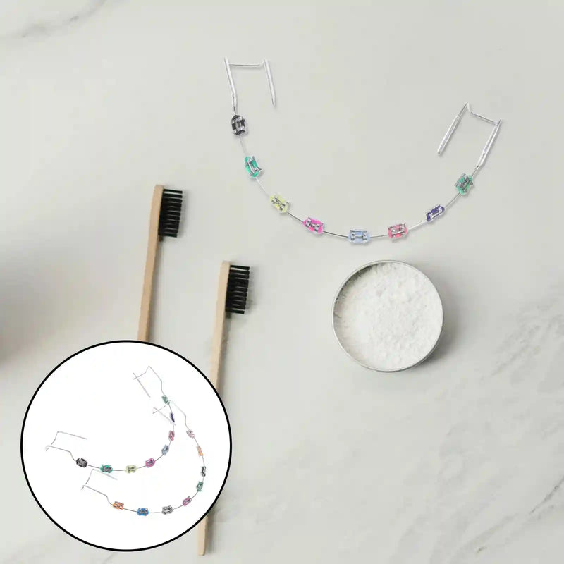 Metal brackets, chain ties, and arch wire applied to teeth correction model for training.