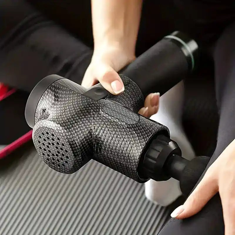 sing a professional massage gun for deep tissue massage on legs and arms.