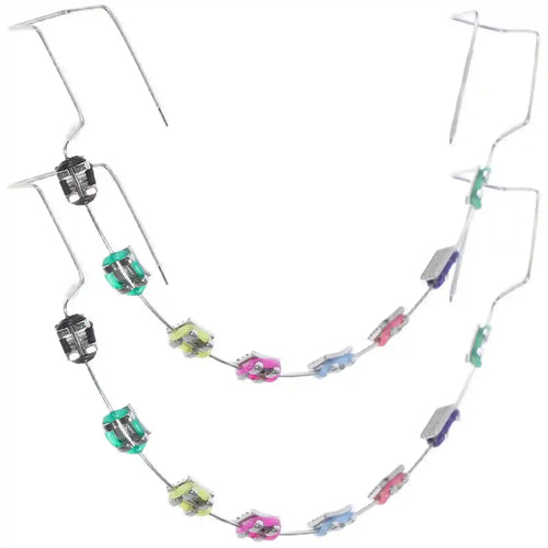 Metal brackets, chain ties, and arch wire applied to teeth correction model for training.