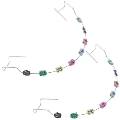 Metal brackets, chain ties, and arch wire applied to teeth correction model for training.