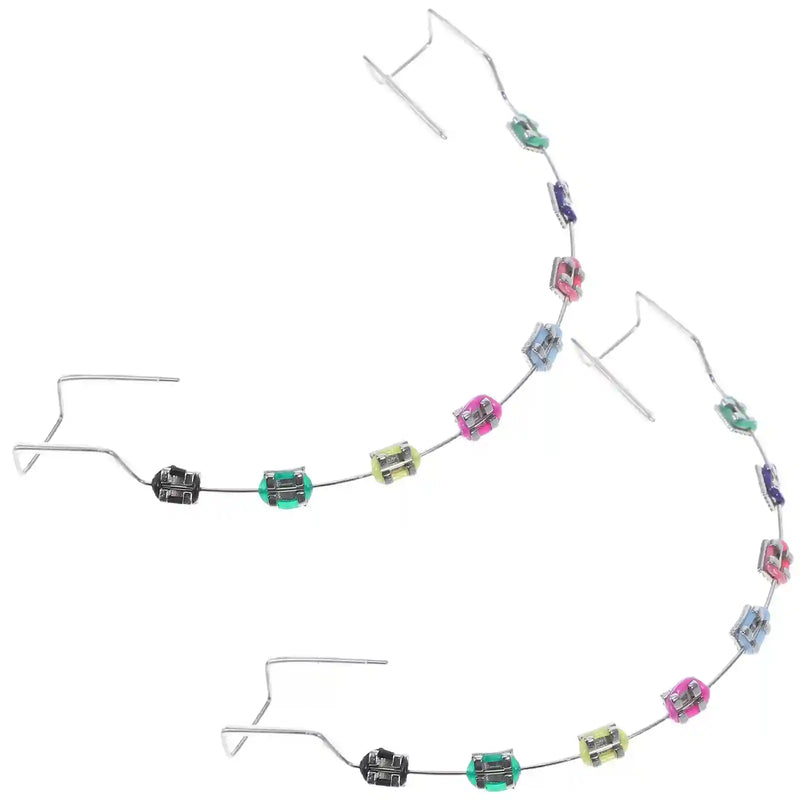 Metal brackets, chain ties, and arch wire applied to teeth correction model for training.