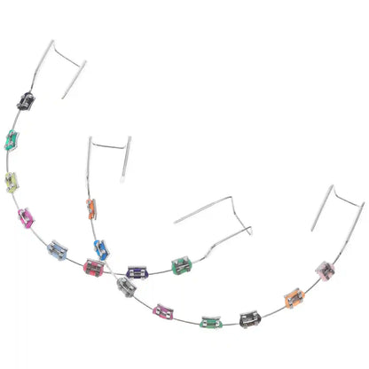 Metal brackets, chain ties, and arch wire applied to teeth correction model for training.