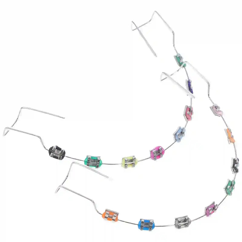 Metal brackets, chain ties, and arch wire applied to teeth correction model for training.