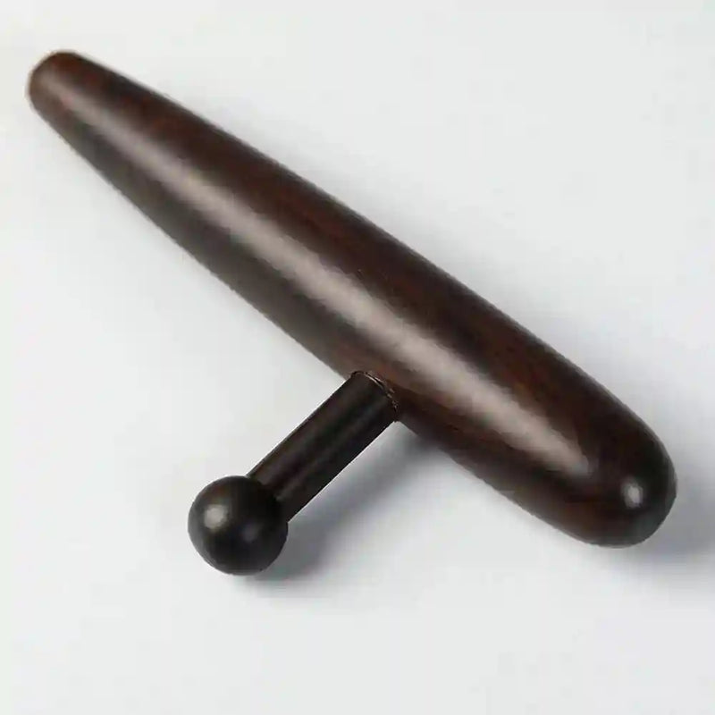 Professional massage therapist using the deep tissue tool to relieve tension in a client’s back.